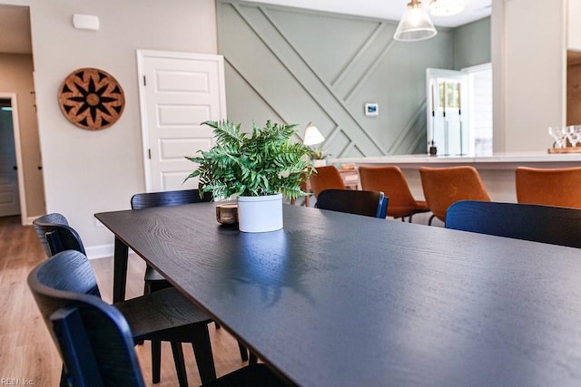 dining space featuring baseboards and wood finished floors