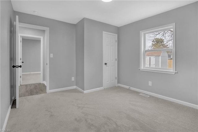 unfurnished bedroom featuring visible vents, carpet flooring, and baseboards