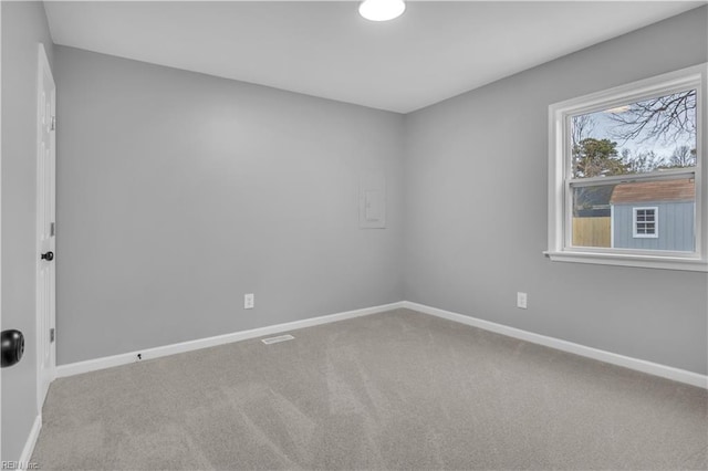 carpeted spare room with baseboards