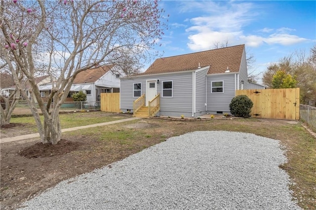 view of front of property featuring crawl space, fence, a shingled roof, and entry steps