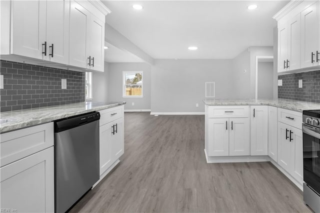 kitchen featuring a peninsula, white cabinets, light wood finished floors, and appliances with stainless steel finishes