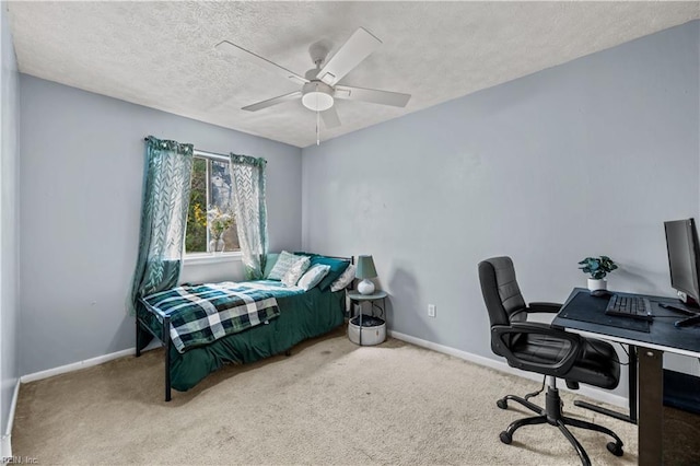 bedroom featuring carpet, baseboards, and a textured ceiling