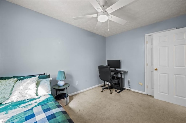 carpeted bedroom featuring a textured ceiling, baseboards, and a ceiling fan