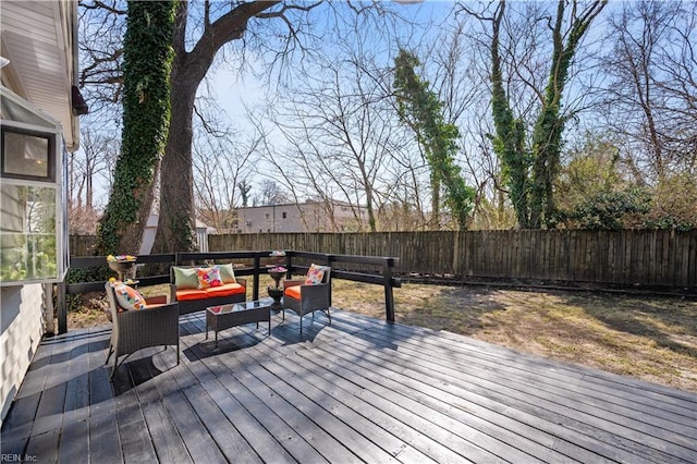 wooden terrace with an outdoor living space and a fenced backyard