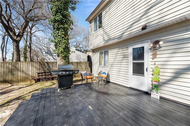 wooden terrace featuring fence and grilling area