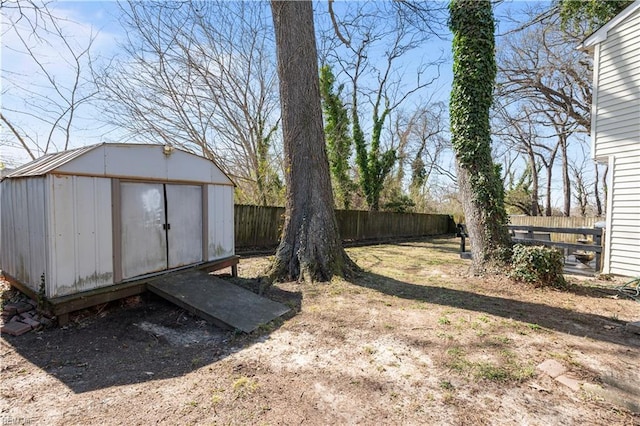 view of yard featuring an outbuilding, a shed, and a fenced backyard