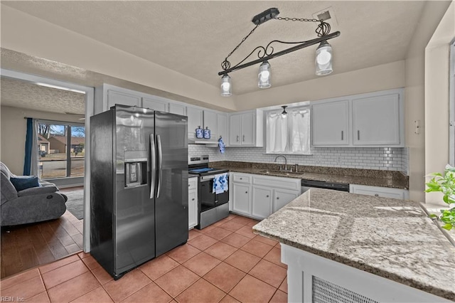 kitchen featuring a sink, stainless steel appliances, backsplash, and light tile patterned floors