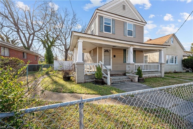 view of front of property featuring a fenced front yard and a porch