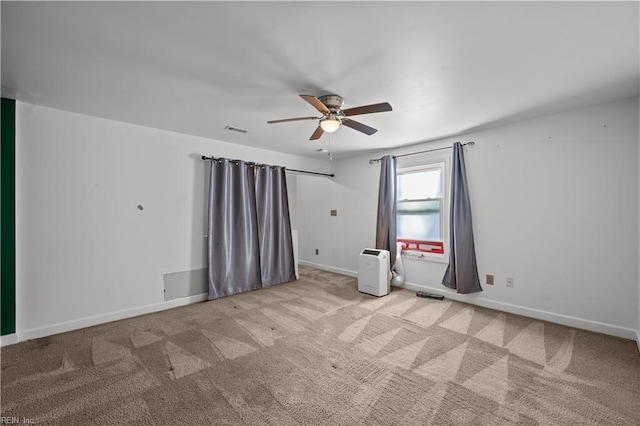 spare room featuring baseboards, carpet floors, and a ceiling fan