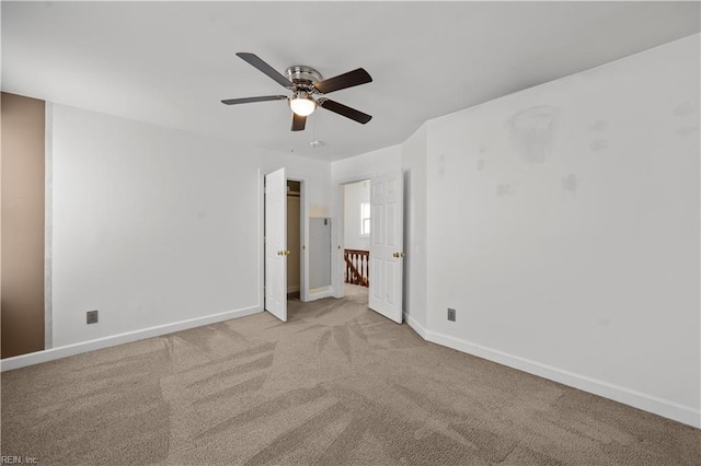 unfurnished bedroom featuring baseboards, carpet floors, and a ceiling fan