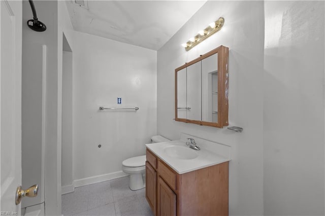 bathroom featuring tile patterned floors, toilet, vanity, and baseboards