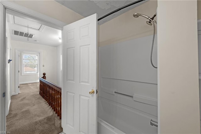 hall featuring attic access, light colored carpet, visible vents, and baseboards