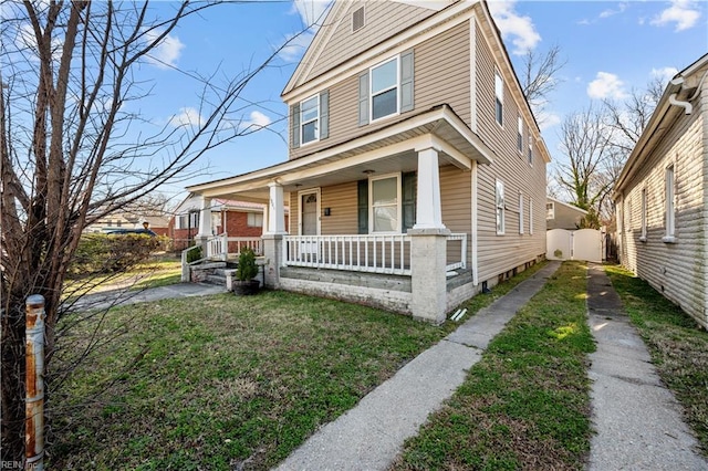 view of front of property featuring covered porch and a front lawn