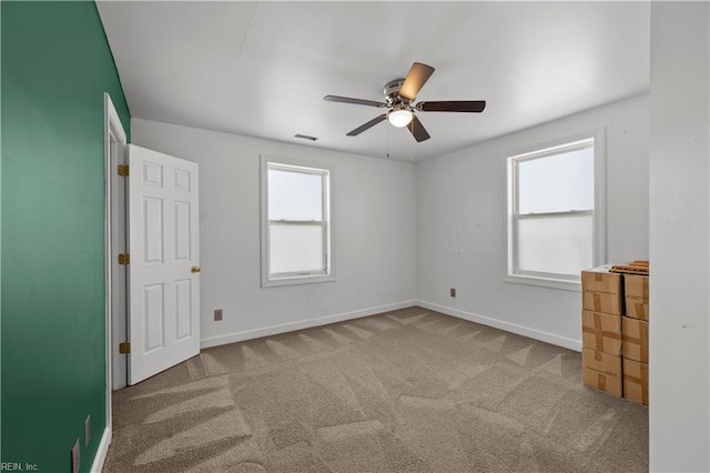 unfurnished bedroom featuring visible vents, baseboards, carpet floors, and ceiling fan