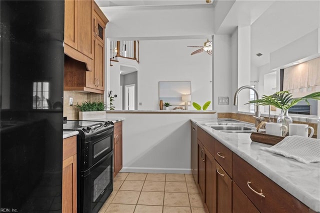 kitchen featuring a ceiling fan, light tile patterned flooring, a sink, black appliances, and tasteful backsplash