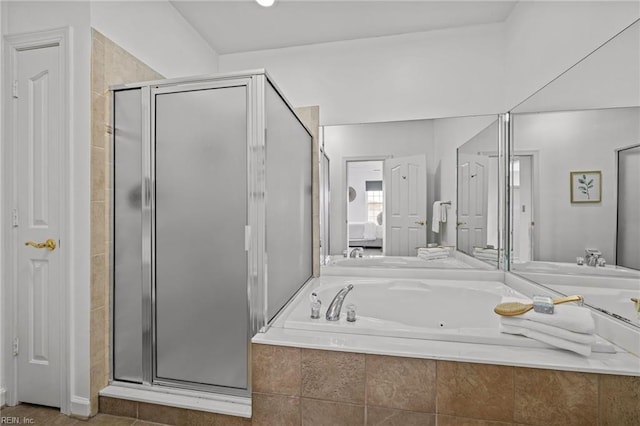 bathroom featuring a garden tub and a shower stall