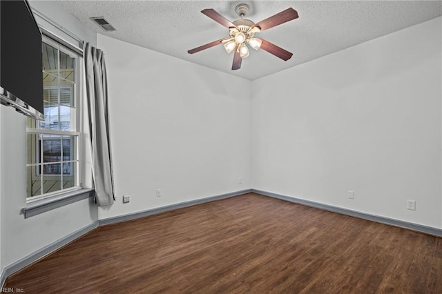 unfurnished room featuring ceiling fan, baseboards, a textured ceiling, and wood finished floors