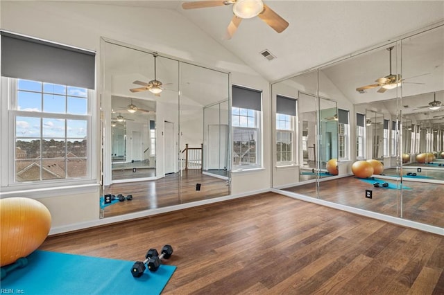 workout area with wood finished floors, visible vents, baseboards, high vaulted ceiling, and ceiling fan