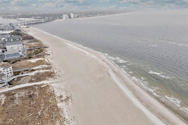 birds eye view of property with a water view and a beach view