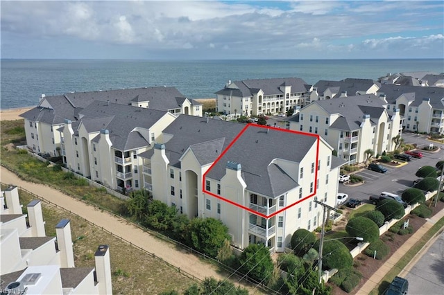 drone / aerial view with a residential view and a water view