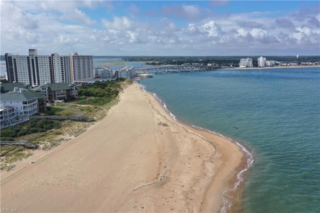 drone / aerial view featuring a city view, a beach view, and a water view