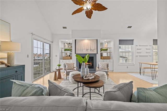 living area with visible vents, ceiling fan, and light wood-style flooring