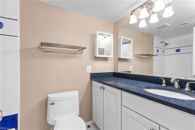 full bath with vanity, toilet, visible vents, and walk in shower