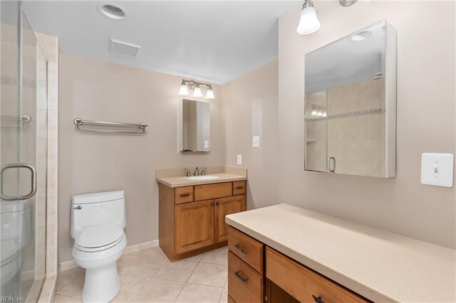 bathroom with tile patterned flooring, toilet, visible vents, and an enclosed shower
