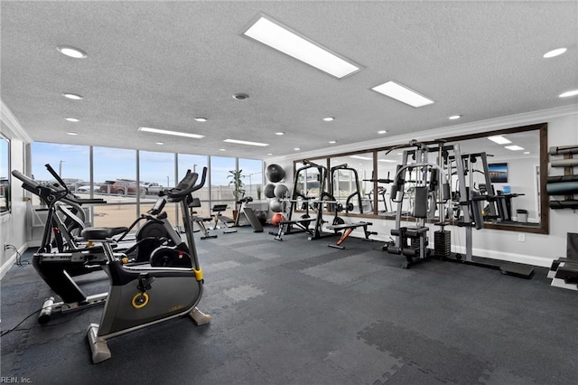 exercise room with crown molding, baseboards, and a textured ceiling
