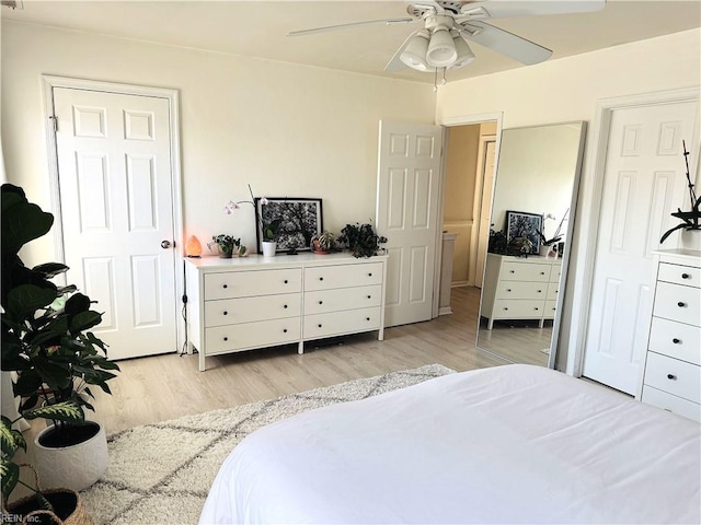 bedroom with light wood-style floors and a ceiling fan