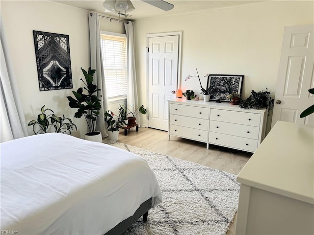 bedroom featuring light wood-style flooring and a ceiling fan