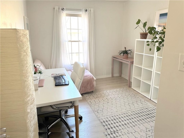 home office featuring wood finished floors and baseboards