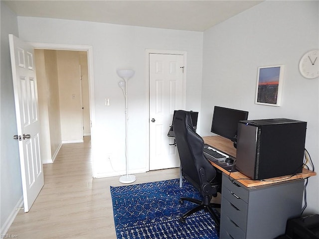 home office featuring light wood-type flooring and baseboards