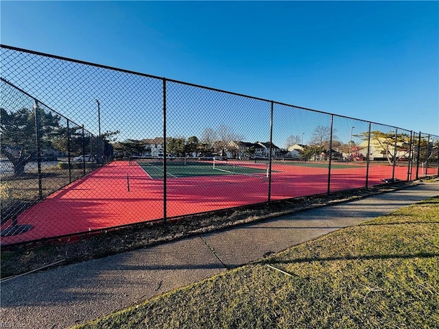 view of tennis court featuring fence