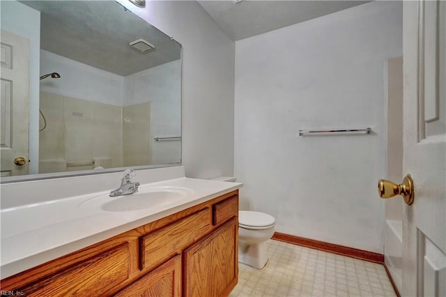 bathroom featuring tile patterned floors, vanity, toilet, and a shower