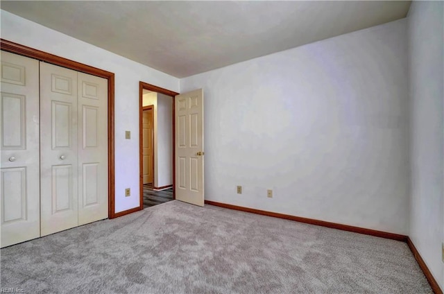 unfurnished bedroom with a closet, baseboards, and carpet