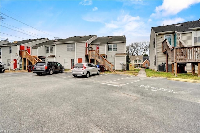 uncovered parking lot with stairway and a residential view