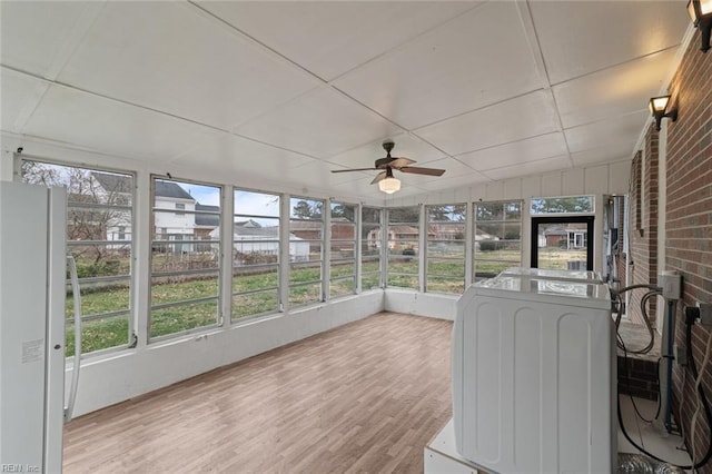 unfurnished sunroom featuring a ceiling fan