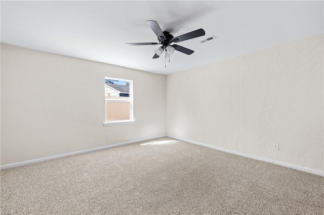 spare room with visible vents, baseboards, ceiling fan, and carpet floors