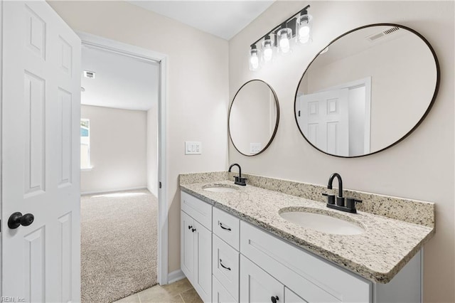 full bath with double vanity, visible vents, and a sink