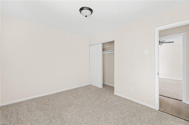 unfurnished bedroom featuring a closet, baseboards, and carpet floors