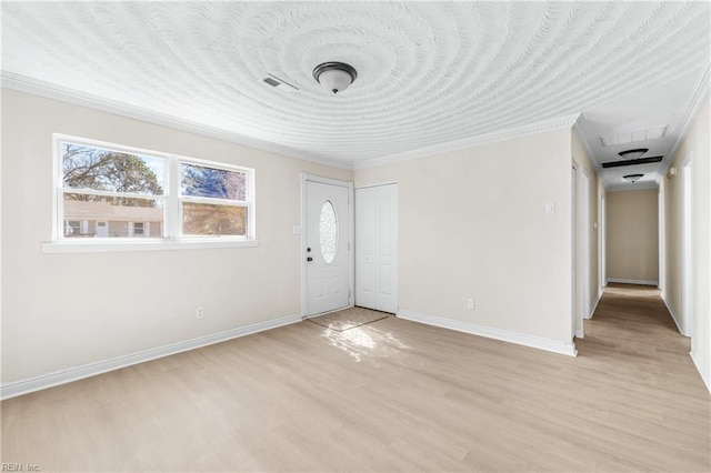 foyer entrance featuring light wood-style flooring, visible vents, and baseboards