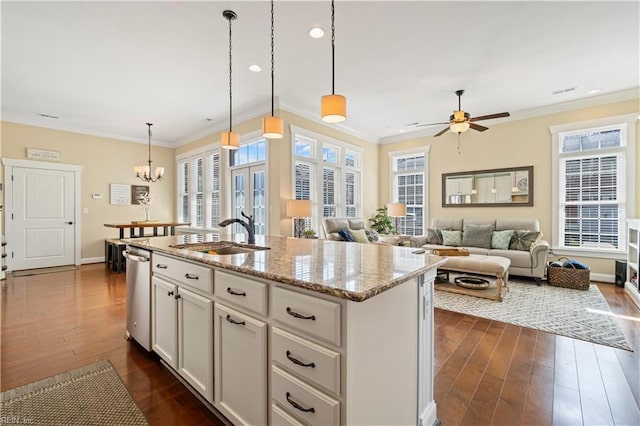 kitchen with ornamental molding, a sink, dark wood-type flooring, stainless steel dishwasher, and ceiling fan with notable chandelier