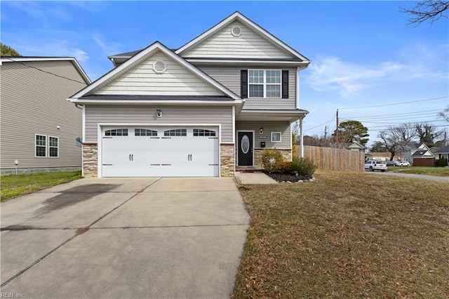 view of front of home featuring stone siding, an attached garage, driveway, and fence