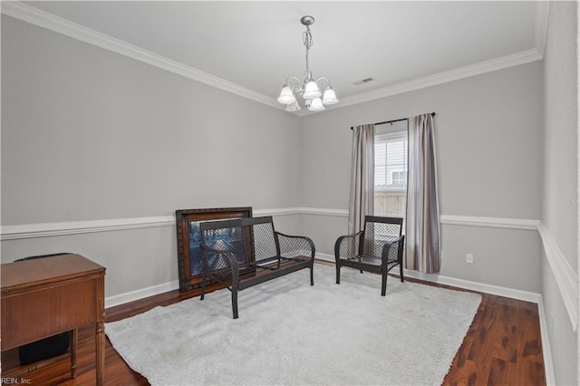 sitting room featuring baseboards, a chandelier, dark wood finished floors, and crown molding