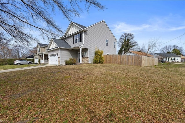 view of property exterior with concrete driveway, an attached garage, fence, and a lawn