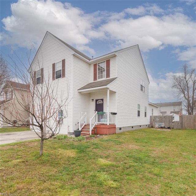 traditional home featuring a front yard, concrete driveway, fence, and crawl space