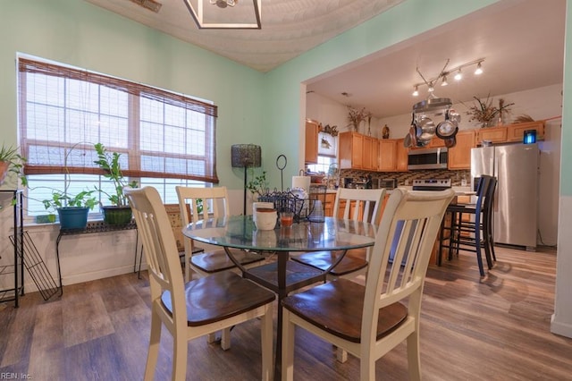 dining room with light wood-type flooring and baseboards