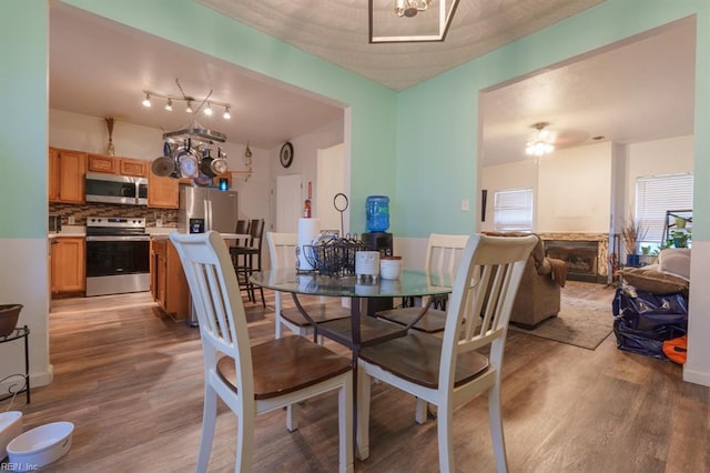 dining area with light wood-type flooring and a chandelier