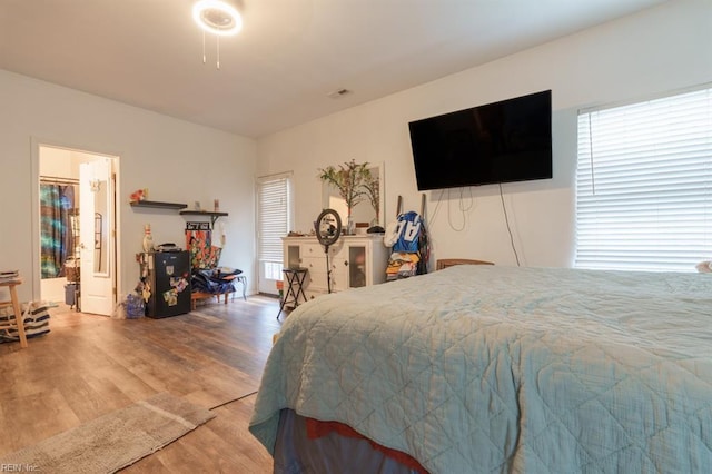 bedroom with visible vents and wood finished floors